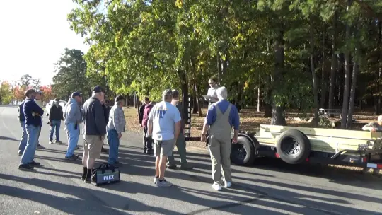 Group gathered near trailer on road