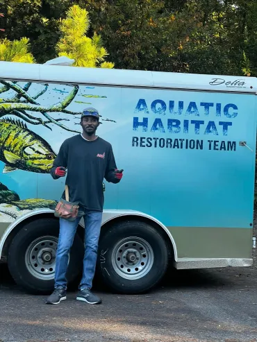 Man standing by Aquatic Habitat trailer