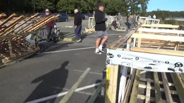 Wooden structures being assembled outdoors