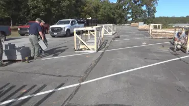 Men unloading boxes near white truck