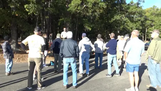 Group gathered outdoors in sunny park