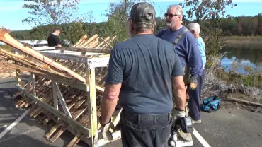 Men working on a wooden project outdoors
