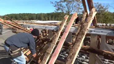 Carpenter working with timber planks