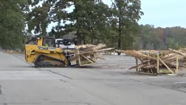 Construction vehicle transporting wood outdoors