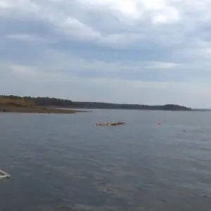 Calm lake with cloudy sky