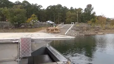 Boat docked at a forested lake
