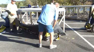 Group preparing gear under sunlight