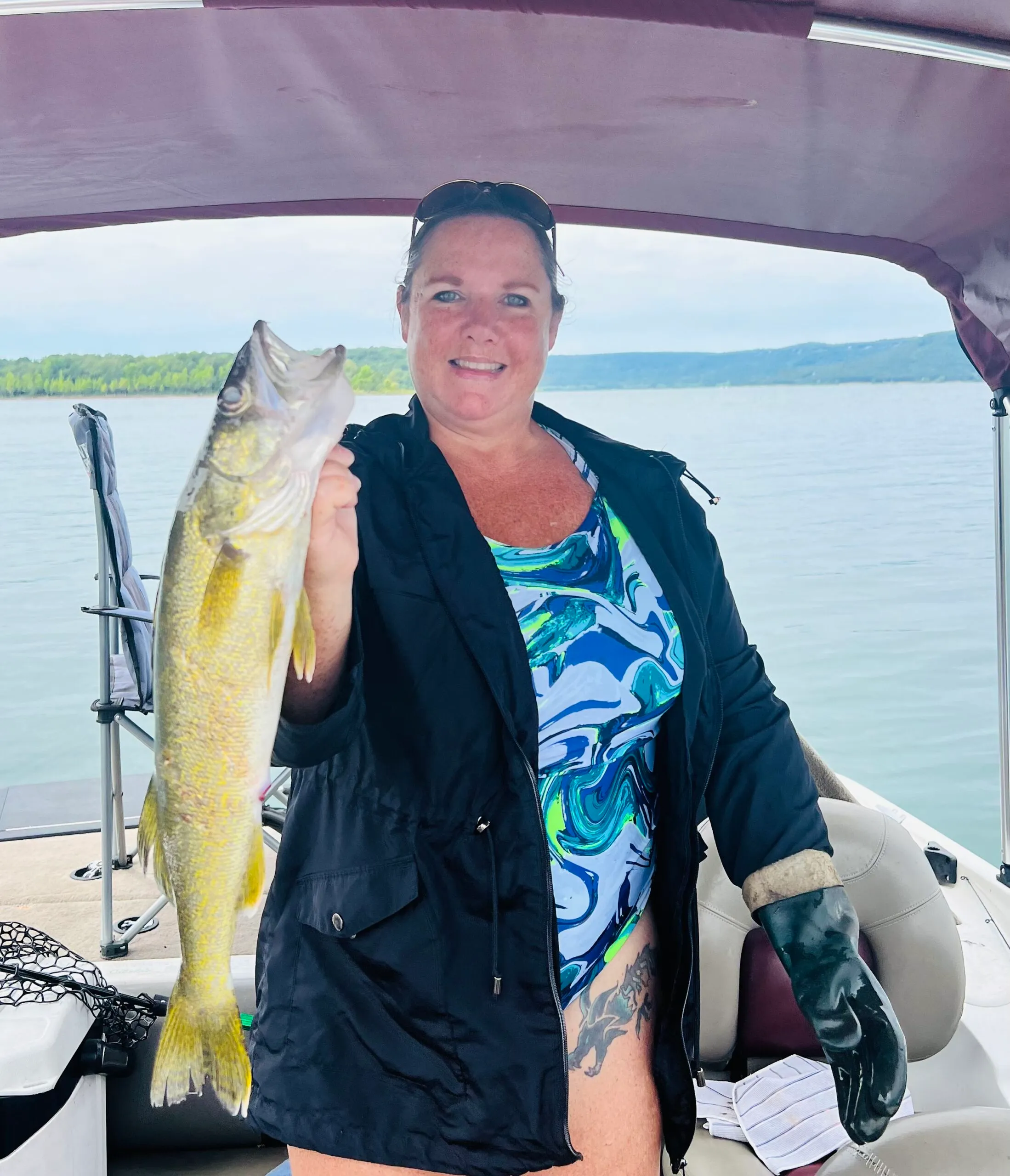 Woman holding a fish on a boat