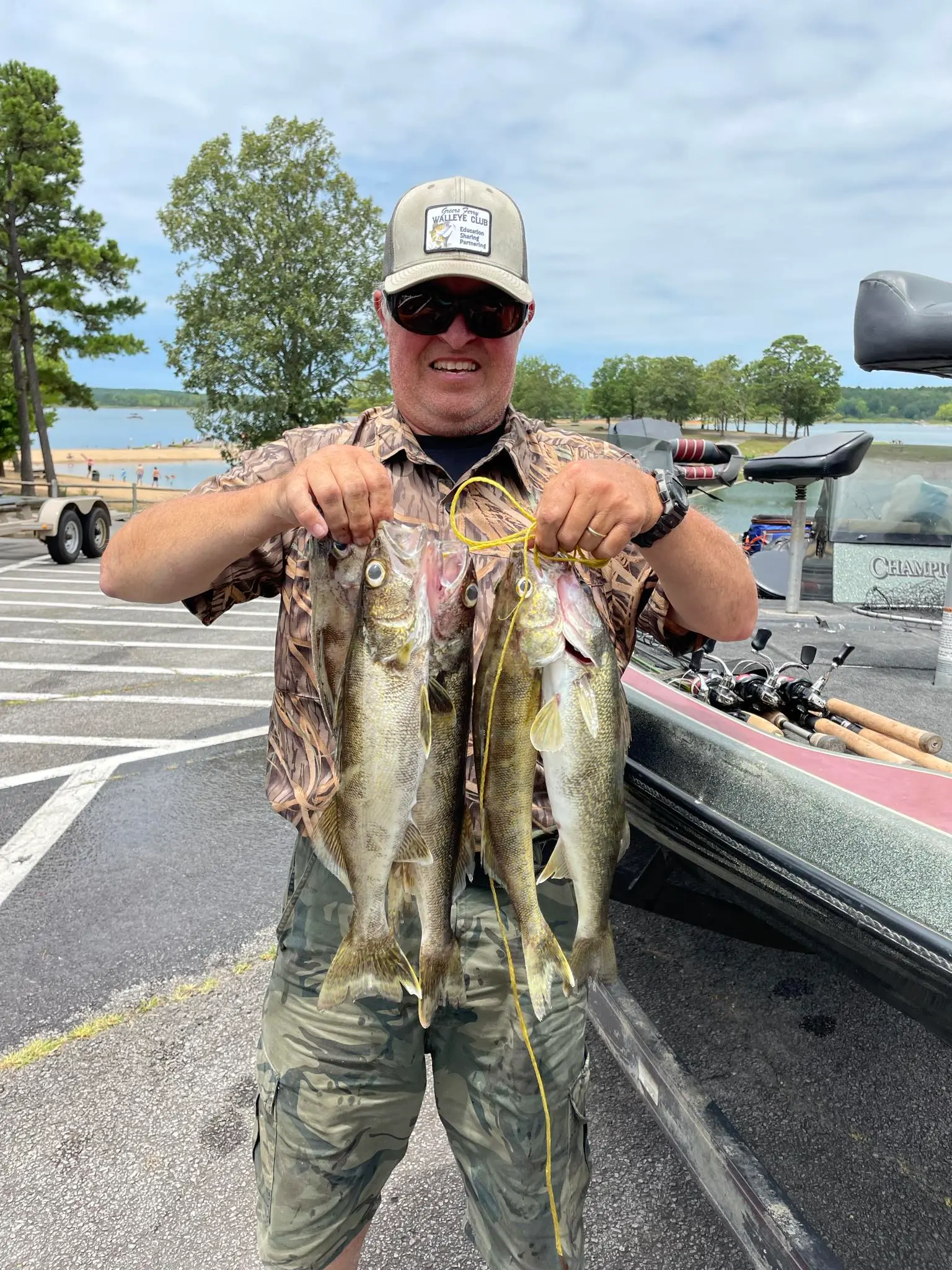 Proud angler with fish by the lake