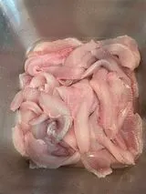 Raw fish fillets in a metal container