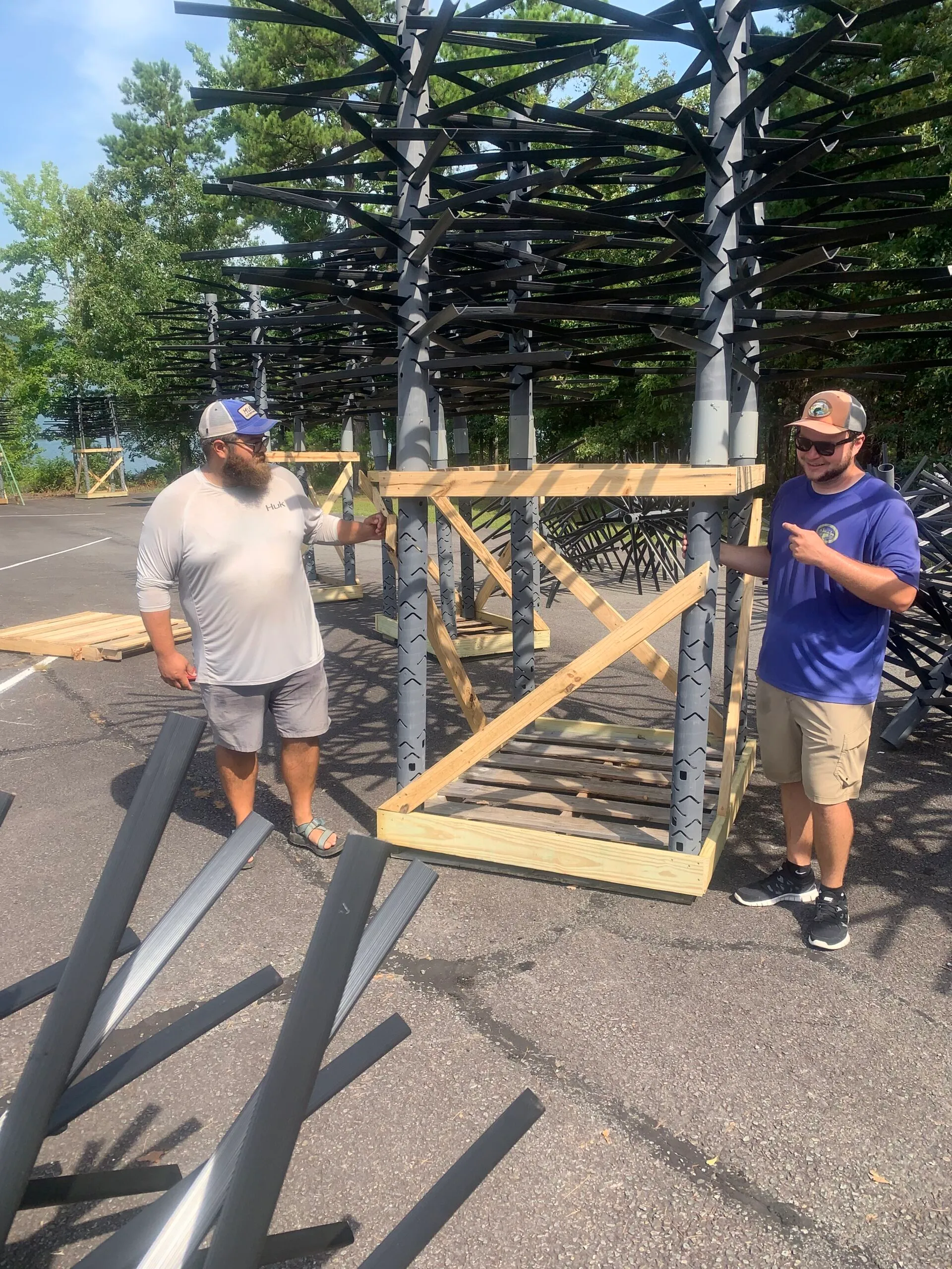 Men assembling outdoor structure in parking lot