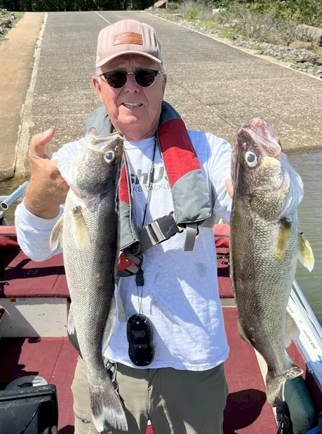 Person showcasing fish after successful fishing trip