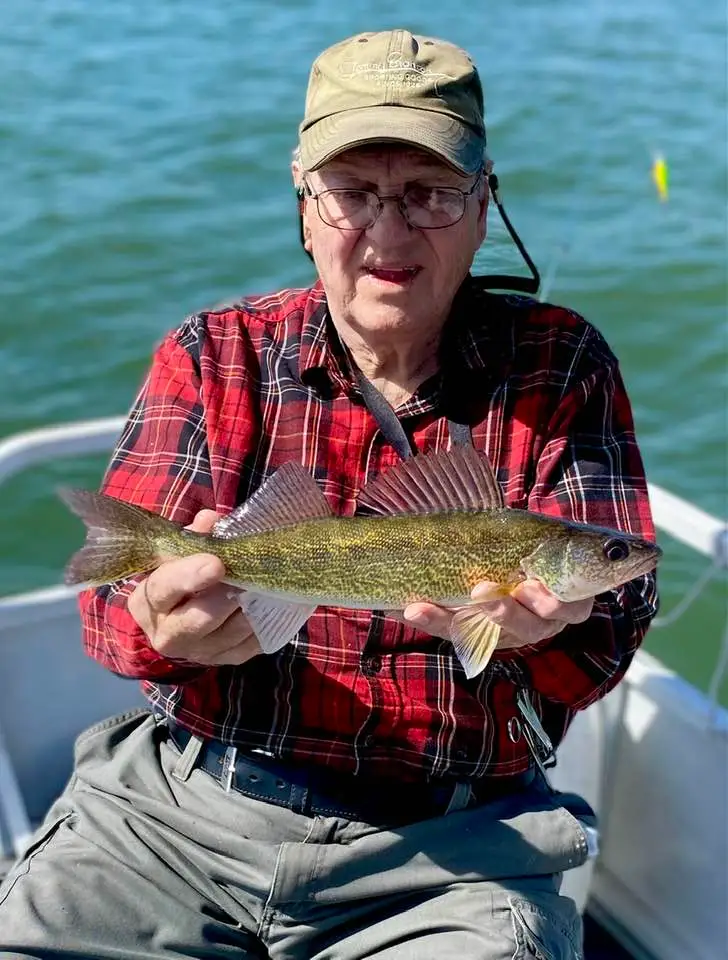 Man holding fish on a boat