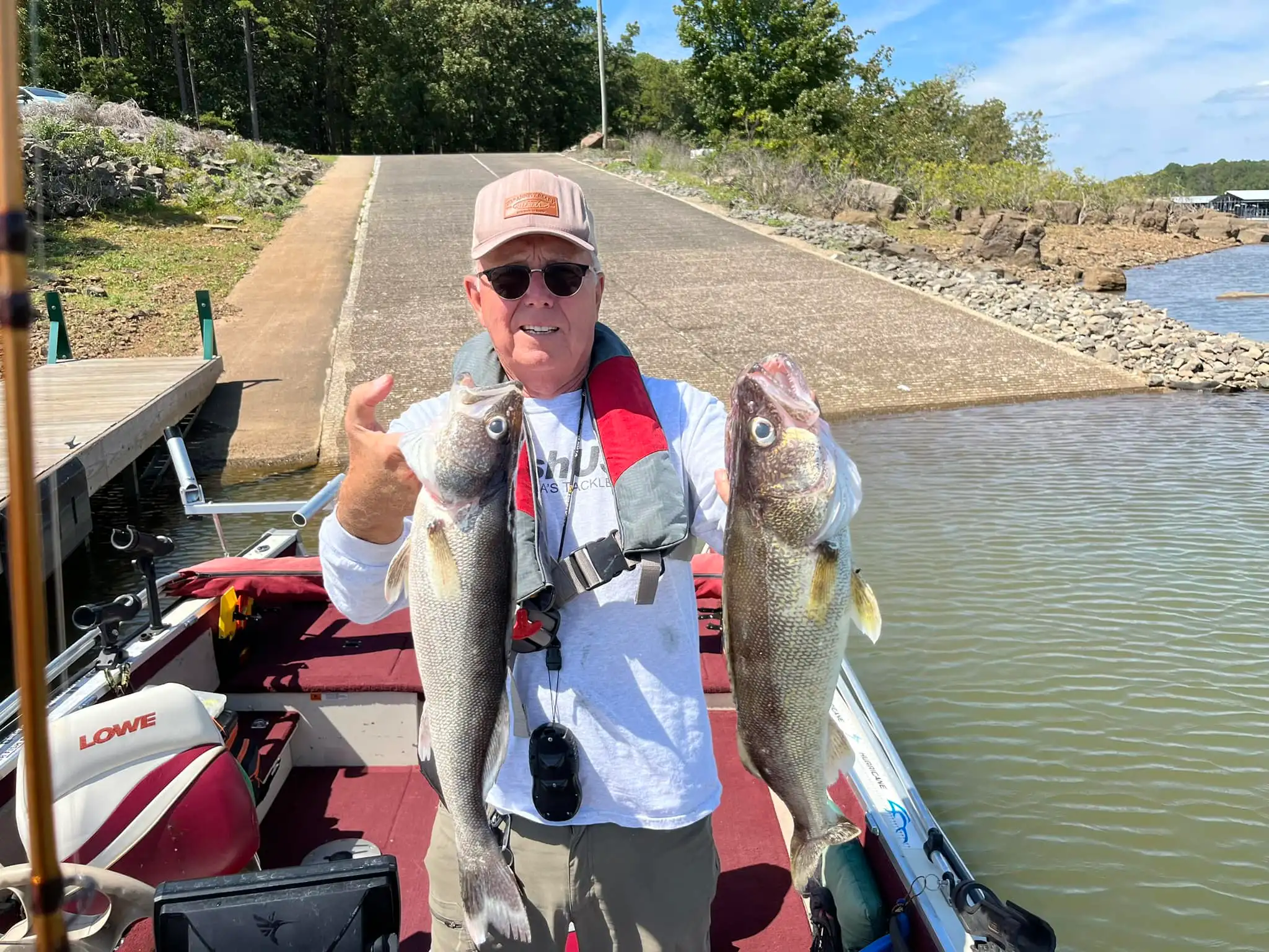 Person displaying freshly caught fish outdoors