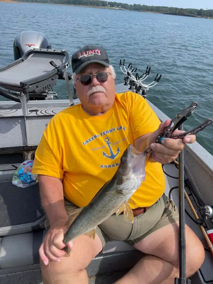 Angler with fish in sunny weather