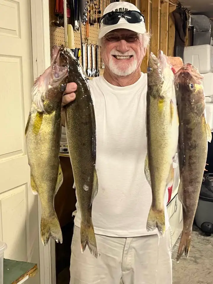 Man holding three large fish